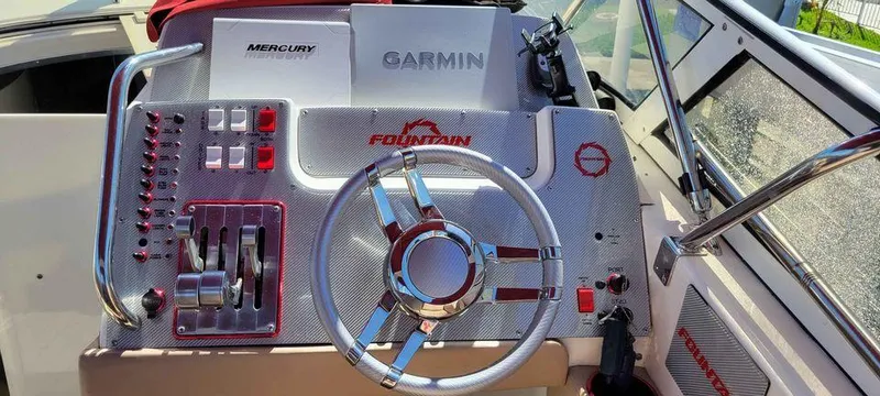 Slide: The Image of Control panel of a 2006 Fountain 38 Express Cruiser with Garmin and Mercury systems. - 5