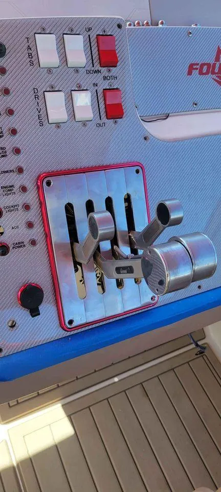 Slide: The Image of Control panel of a 2006 Fountain 38 Express Cruiser with throttle levers and switches. - 6