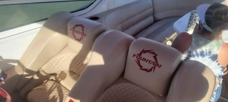 Slide: The Image of 2006 Fountain 38 Express Cruiser interior with beige seating and logo embroidery. - 8