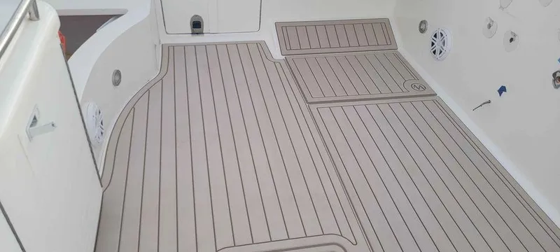 Slide: The Image of 2006 Fountain 38 Express Cruiser deck with sleek, modern design and wood-like flooring. - 9