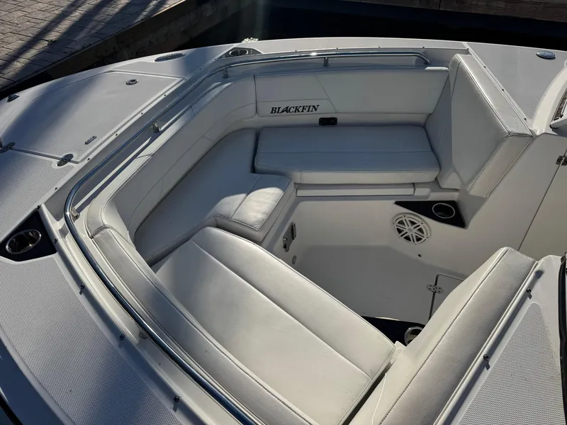 Slide: The Image of 2021 Blackfin 252DC boat interior with white seating and speaker system. - 30
