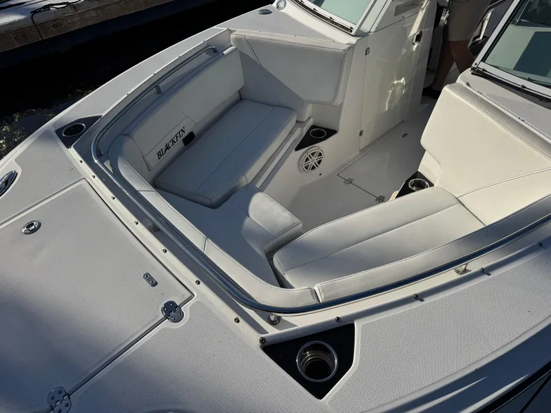 Slide: The Image of 2021 Blackfin 252DC boat interior with white seating and cup holders. - 31