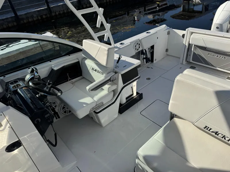 Slide: The Image of 2021 Blackfin 252DC boat interior with white seating and modern controls. - 32
