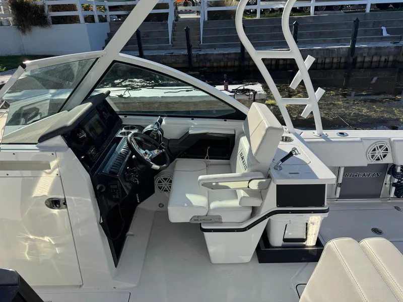 Slide: The Image of 2021 Blackfin 252DC boat interior with helm, seating, and modern controls. - 36