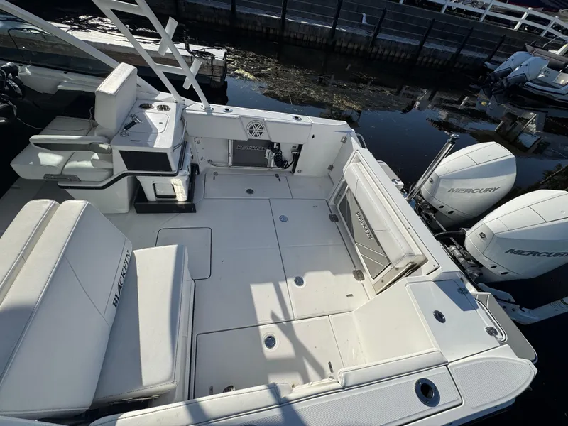 Slide: The Image of 2021 Blackfin 252DC boat interior with seating and dual Mercury engines. - 39