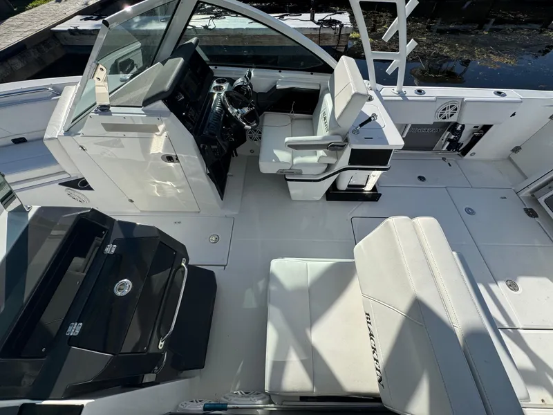 Slide: The Image of 2021 Blackfin 252DC boat interior with helm, seating, and modern controls. - 40