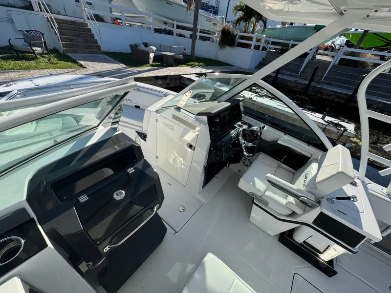 Slide: The Image of 2021 Blackfin 252DC boat interior with modern helm and seating area. - 41