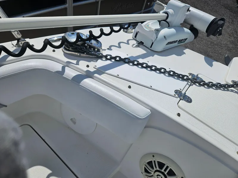 Slide: The Image of 2014 Carolina Cat 230 DC boat deck with anchor chain and motorized winch. - 22