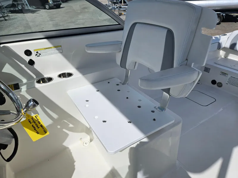 Slide: The Image of 2014 Carolina Cat 230 DC boat interior with steering wheel and seating. - 24