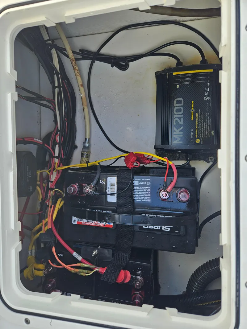 Slide: The Image of Battery compartment of 2014 Carolina Cat 230 DC with wiring and MK210D charger. - 25