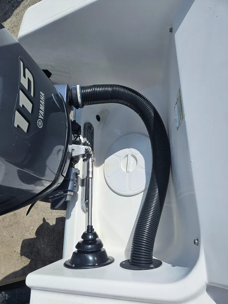 Slide: The Image of 2014 Carolina Cat 230 DC boat engine compartment with Yamaha 115 motor. - 27