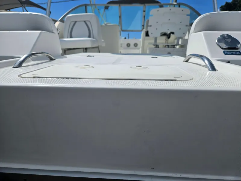 Slide: The Image of 2014 Carolina Cat 230 DC boat interior with seating and fresh water access. - 28