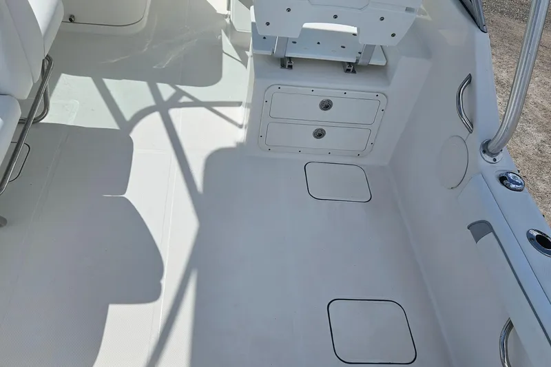 Slide: The Image of 2014 Carolina Cat 230 DC boat interior with storage compartments and seating. - 29