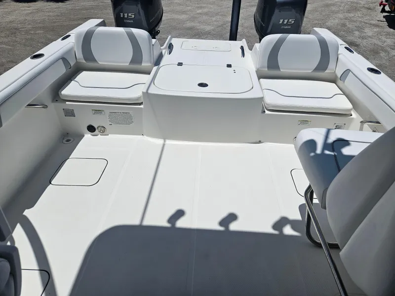 Slide: The Image of 2014 Carolina Cat 230 DC boat interior with seating and dual Yamaha 115 engines. - 3