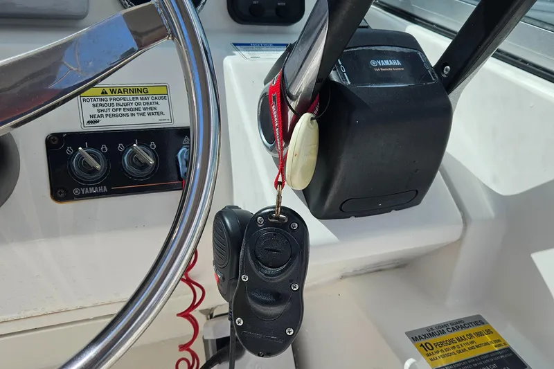Slide: The Image of Steering wheel and controls of 2014 Carolina Cat 230 DC boat with Yamaha components. - 35