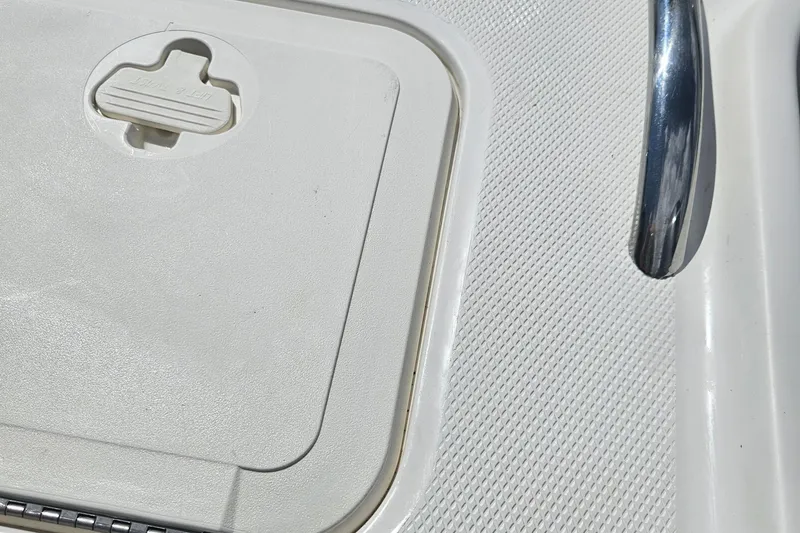 Slide: The Image of 2014 Carolina Cat 230 DC boat deck with hatch and chrome handle. - 38