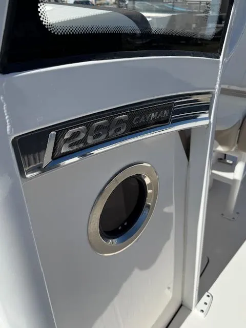 Slide: The Image of 2025 Robalo 266 Cayman boat detail with logo and porthole. - 10