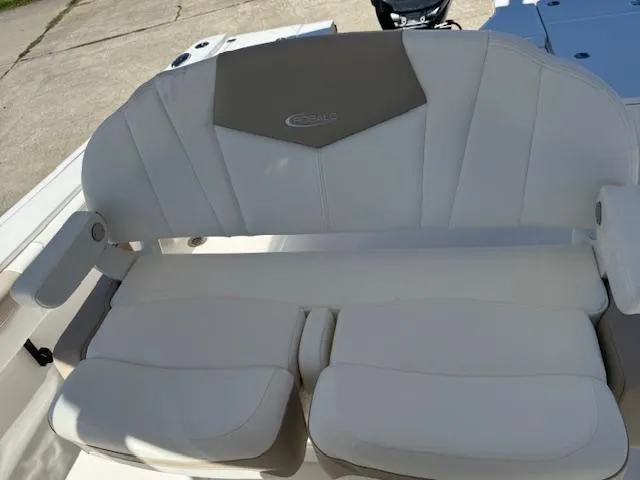 Slide: The Image of 2025 Robalo 266 Cayman boat seat with white cushioned upholstery. - 13