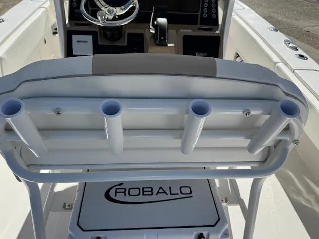 Slide: The Image of 2025 Robalo 266 Cayman boat interior with rod holders and steering console. - 15