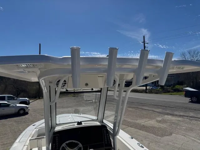 Slide: The Image of 2025 Robalo 266 Cayman boat with T-top and rod holders under a clear blue sky. - 23