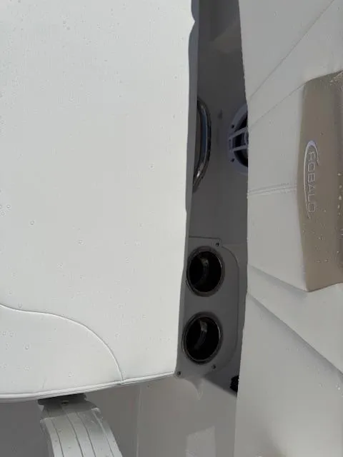 Slide: The Image of 2025 Robalo 266 Cayman boat interior with white seating and speaker system. - 24