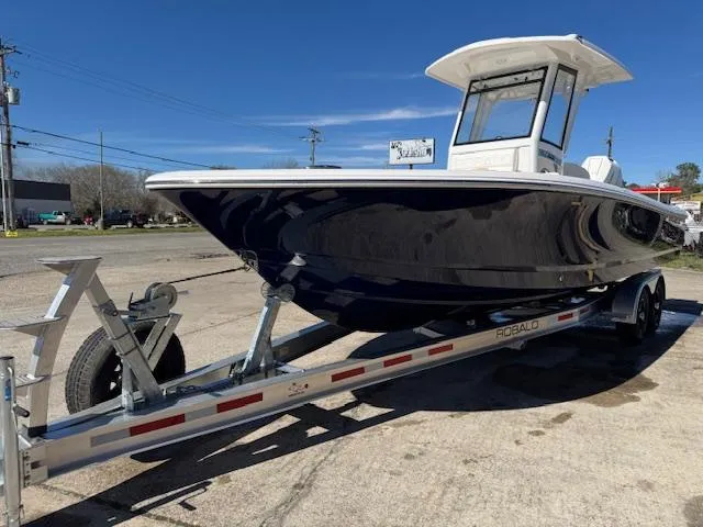 Slide: The Image of 2025 Robalo 266 Cayman boat on trailer, parked outdoors under clear blue sky. - 5