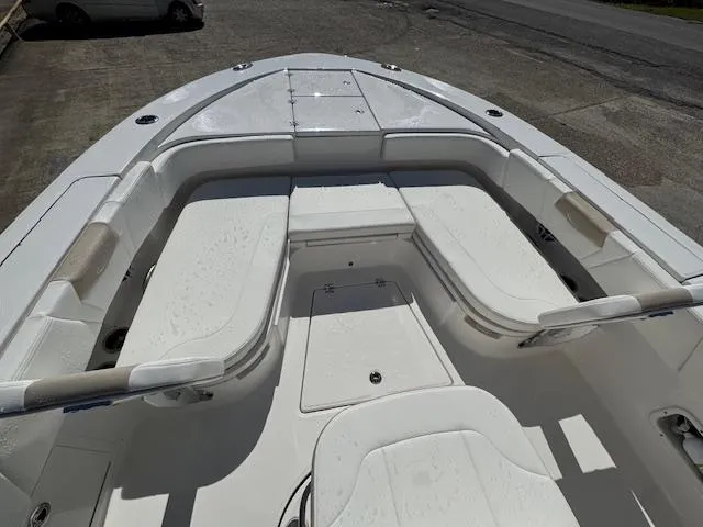 Slide: The Image of 2025 Robalo 266 Cayman boat interior with white seating and storage compartments. - 6