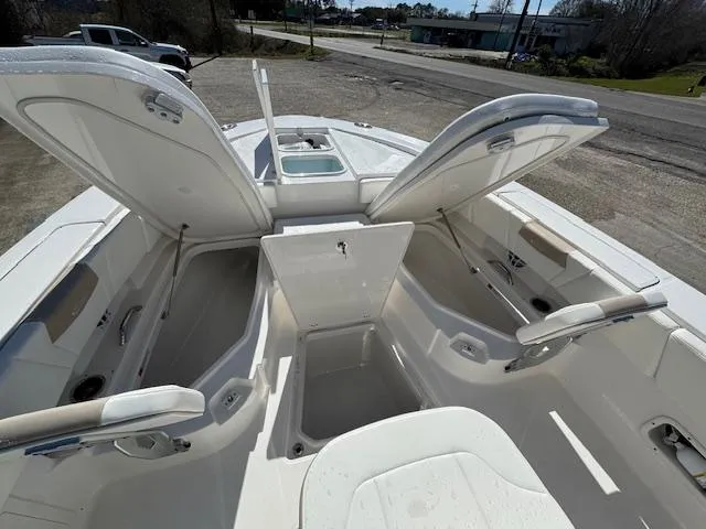 Slide: The Image of 2025 Robalo 266 Cayman boat interior with open storage compartments and seating. - 7