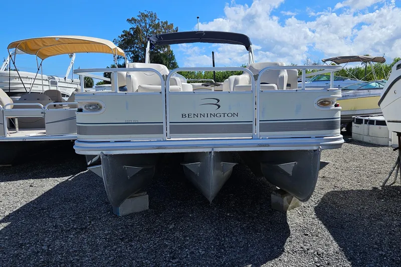 Slide: The Image of 2007 Bennington 2577RFS pontoon boat on gravel lot under blue sky. - 11