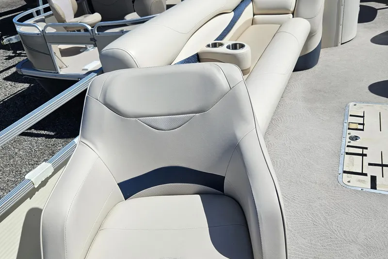 Slide: The Image of 2007 Bennington 2577RFS boat interior with beige seating and cup holders. - 14