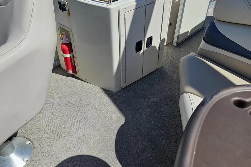 Slide: The Image of Interior of a 2007 Bennington 2577RFS boat with seating and a fire extinguisher. - 17