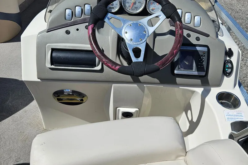 Slide: The Image of 2007 Bennington 2577RFS boat dashboard with steering wheel and control panel. - 18