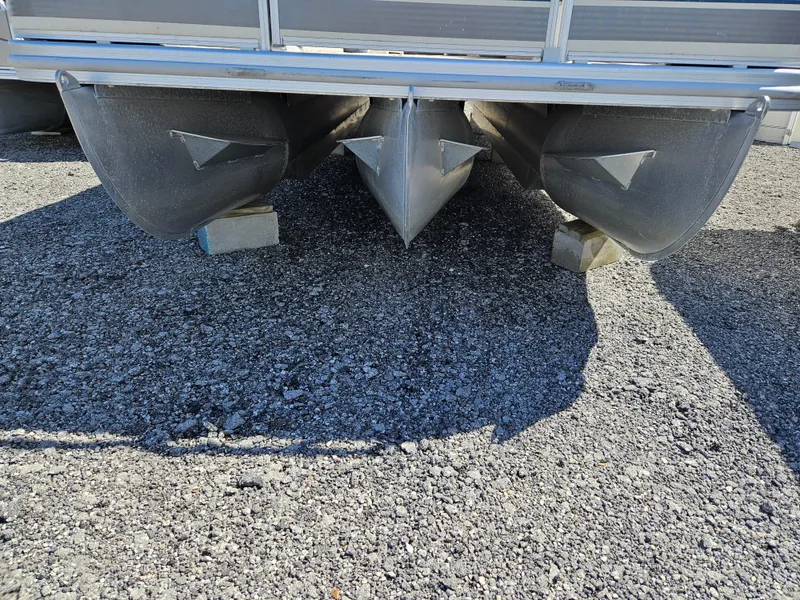 Slide: The Image of 2007 Bennington 2577RFS pontoon boat hulls on gravel surface. - 3