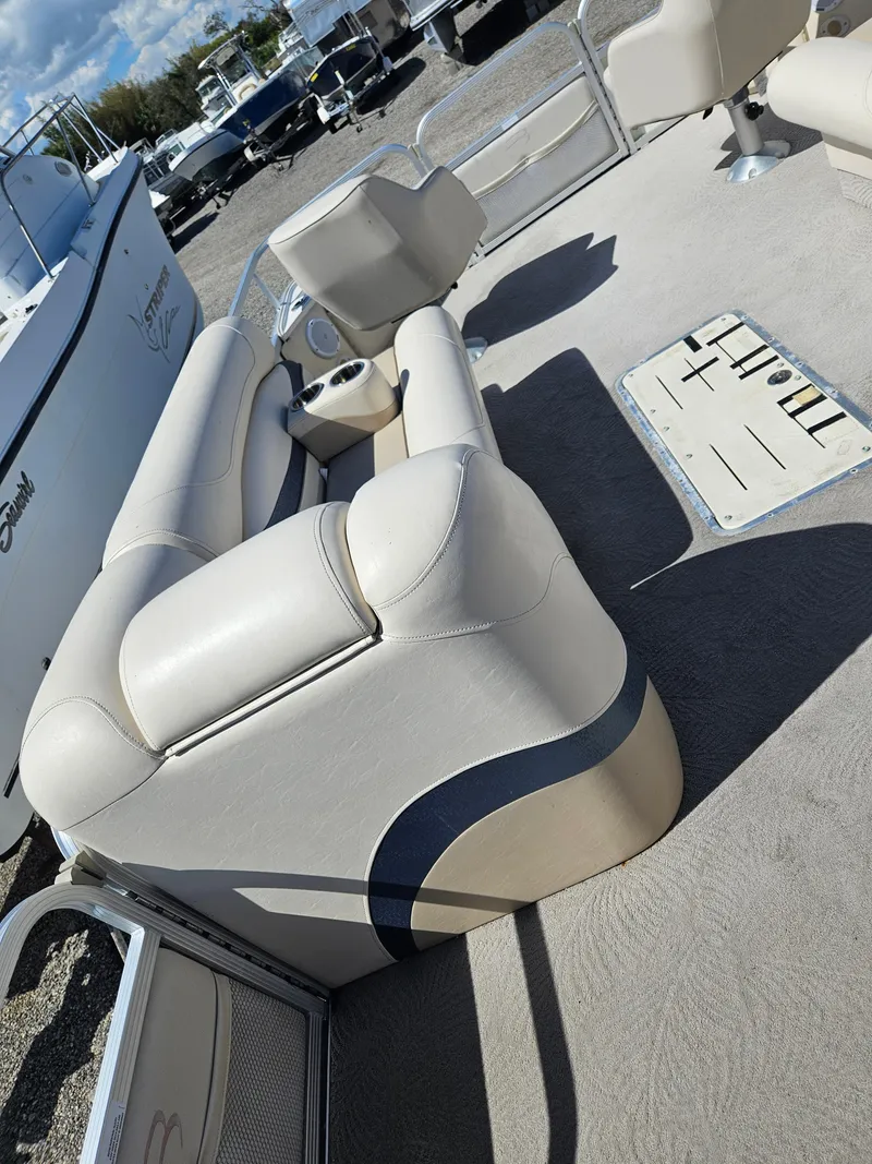 Slide: The Image of 2007 Bennington 2577RFS pontoon boat interior with beige seating and carpet. - 5