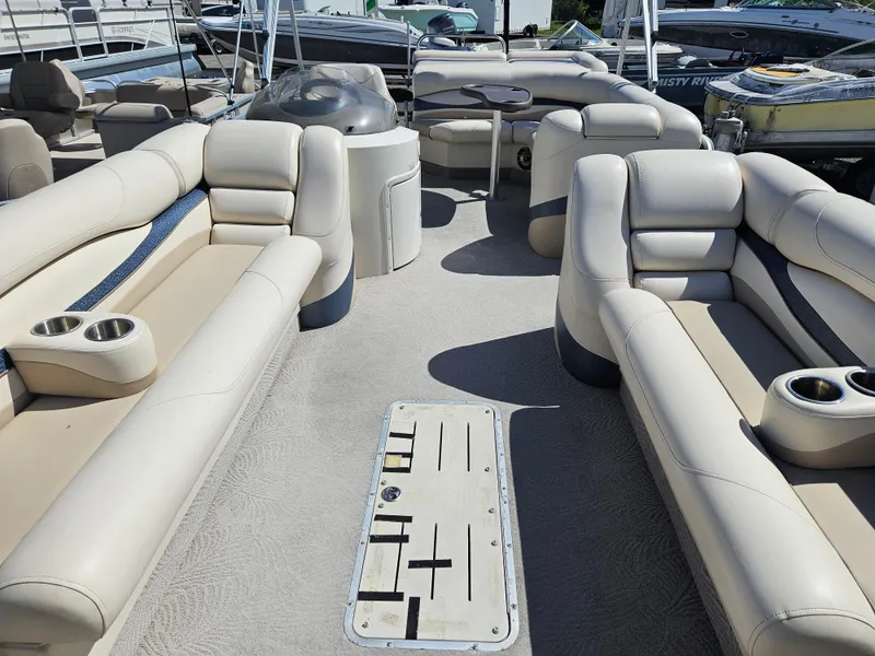 Slide: The Image of 2007 Bennington 2577RFS pontoon boat interior with beige seating and cup holders. - 9