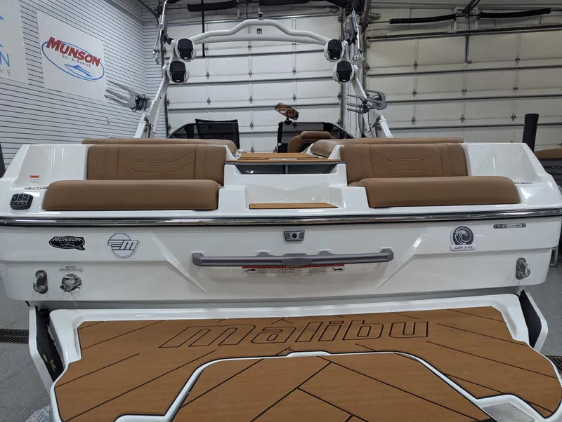 Slide: The Image of 2025 Malibu Wakesetter 23 LSV boat interior with tan seating and branded flooring. - 10