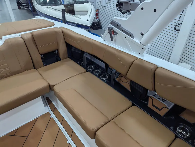 Slide: The Image of 2025 Malibu Wakesetter 23 LSV interior with tan leather seating and modern design. - 16