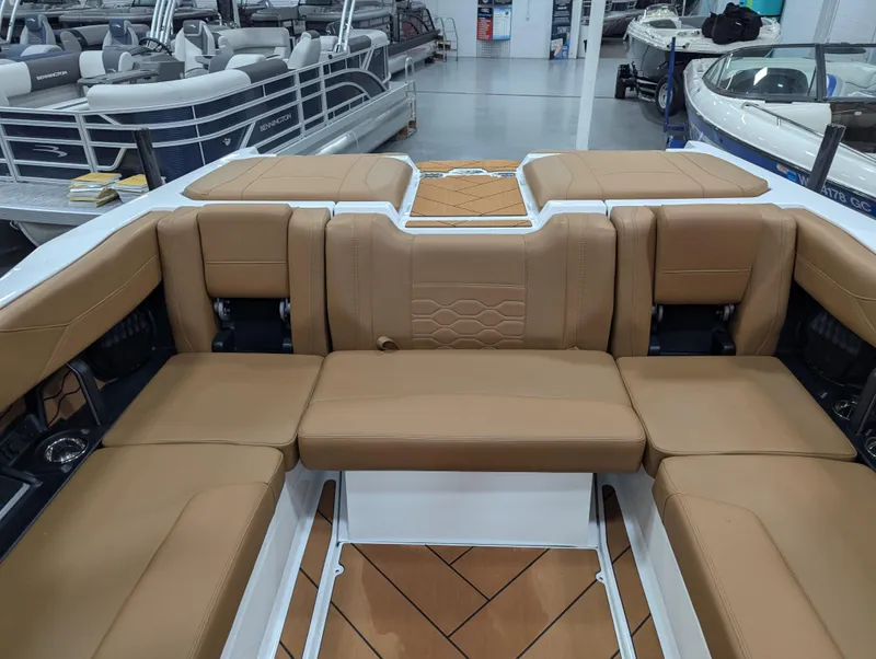 Slide: The Image of 2025 Malibu Wakesetter 23 LSV interior with tan leather seating in showroom. - 17