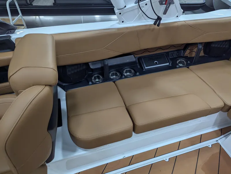 Slide: The Image of 2025 Malibu Wakesetter 23 LSV interior with tan leather seating and cup holders. - 18