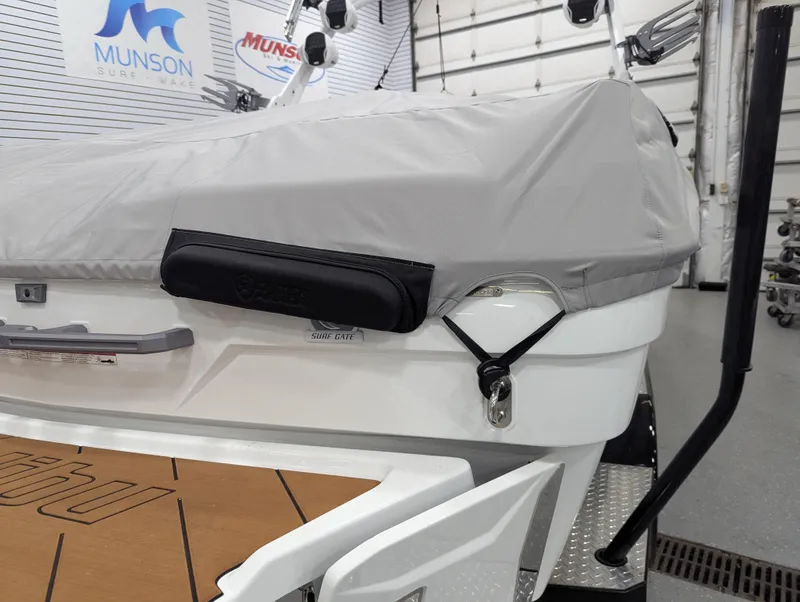 Slide: The Image of 2025 Malibu Wakesetter 23 LSV boat with cover in showroom setting. - 25