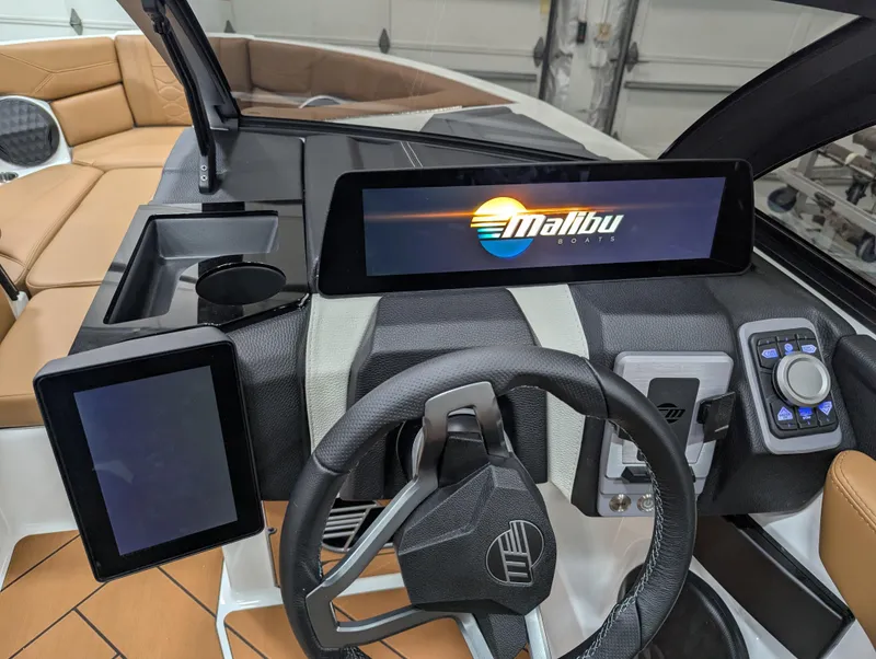 Slide: The Image of 2025 Malibu Wakesetter 23 LSV dashboard with digital displays and steering wheel. - 6