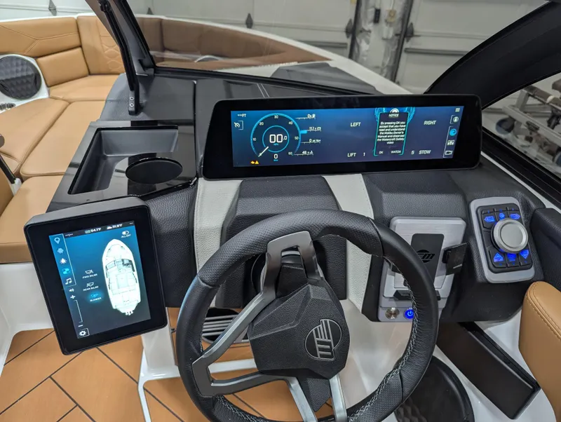 Slide: The Image of 2025 Malibu Wakesetter 23 LSV dashboard with digital displays and steering wheel. - 7