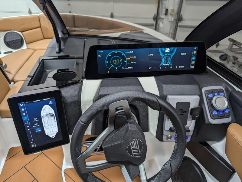 Slide: The Image of 2025 Malibu Wakesetter 23 LSV dashboard with advanced digital displays and steering wheel. - 8
