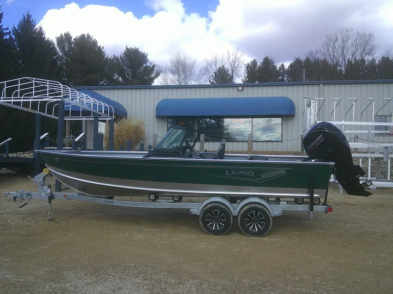 The Image of 2025 Lund 2075 Alaskan Sport boat on trailer, parked outdoors. - 1