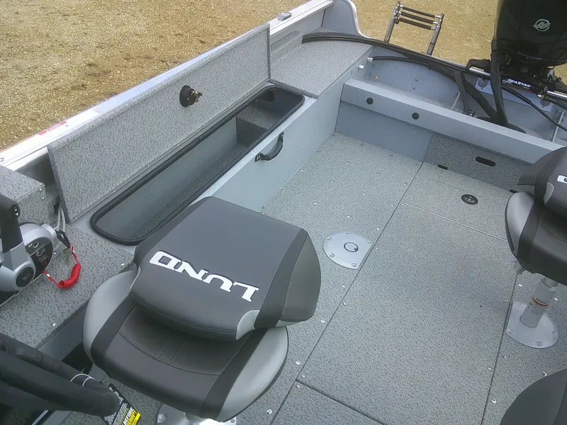 Slide: The Image of 2025 Lund 2075 Alaskan Sport boat interior with seating and storage compartments. - 11
