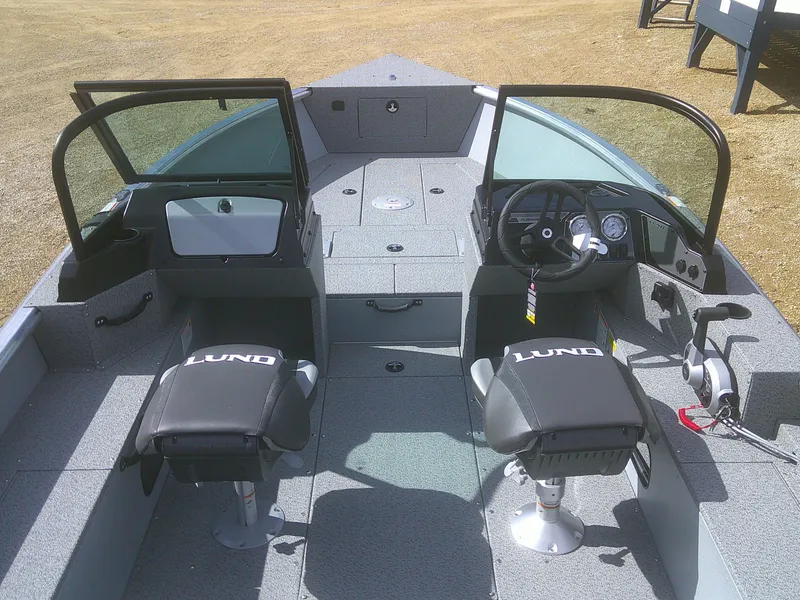 Slide: The Image of 2025 Lund 2075 Alaskan Sport boat interior with dual seats and steering console. - 13