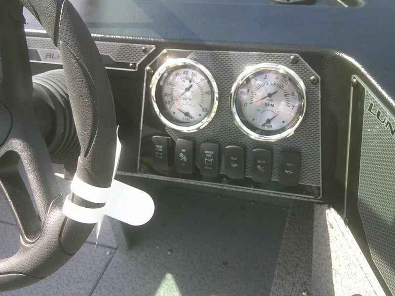 Slide: The Image of 2025 Lund 2075 Alaskan Sport dashboard with steering wheel and gauges. - 16