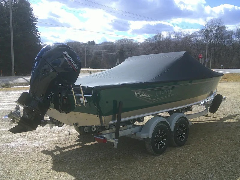 Slide: The Image of 2025 Lund 2075 Alaskan Sport boat on trailer, covered, with Mercury outboard motor. - 18
