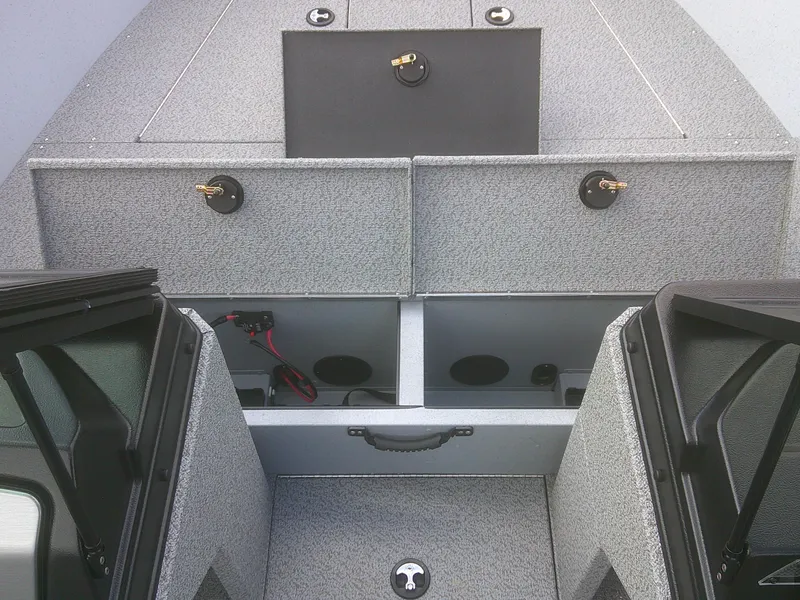 Slide: The Image of 2025 Lund 2075 Alaskan Sport boat interior with storage compartments and gray textured finish. - 6