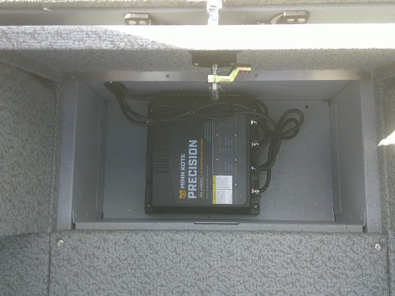 Slide: The Image of Minn Kota Precision charger in 2025 Lund 2075 Alaskan Sport boat compartment. - 7